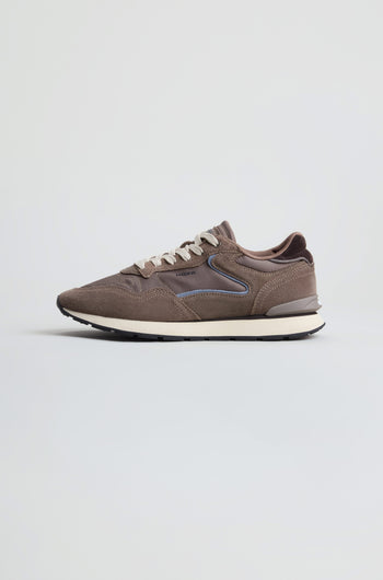 Side view of the City Trainers in brown premium suede, featuring white laces, a white midsole, and a black outsole, displayed against a plain light background.