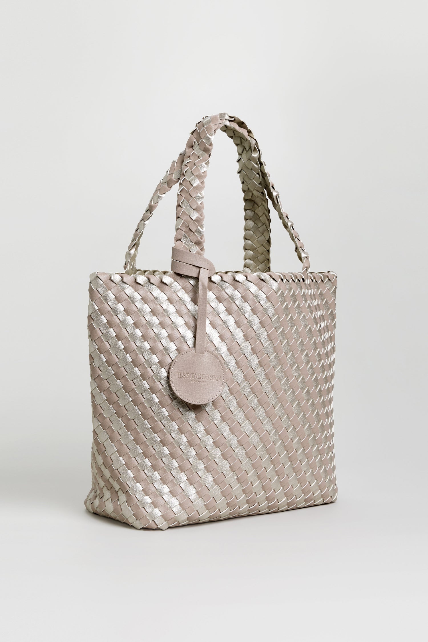 A Woven Reversible Grey & Silver Bag with two handles and a round attached tag, shown against a plain white background.