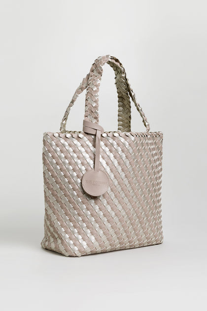 A Woven Reversible Grey & Silver Bag with two handles and a round attached tag, shown against a plain white background.