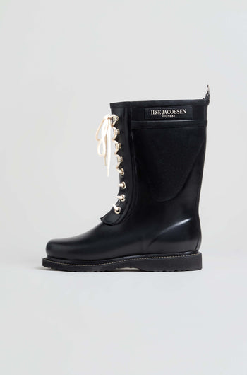 The Lace Up Wellington Boots, crafted from high-quality natural rubber, feature a black lace-up design with white laces and a prominent “ILSE JACOBSEN HORNBÆK” label on the shaft. Displayed against a plain light background, these stylish boots are an ideal choice for wet-weather wear.