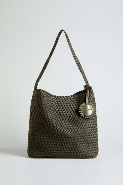 The Olive Braided Shoulder Bag by Ilse Jacobsen, featuring a woven olive green design with a single strap and a round metallic tag attached to the handle, is displayed against a plain light background.
