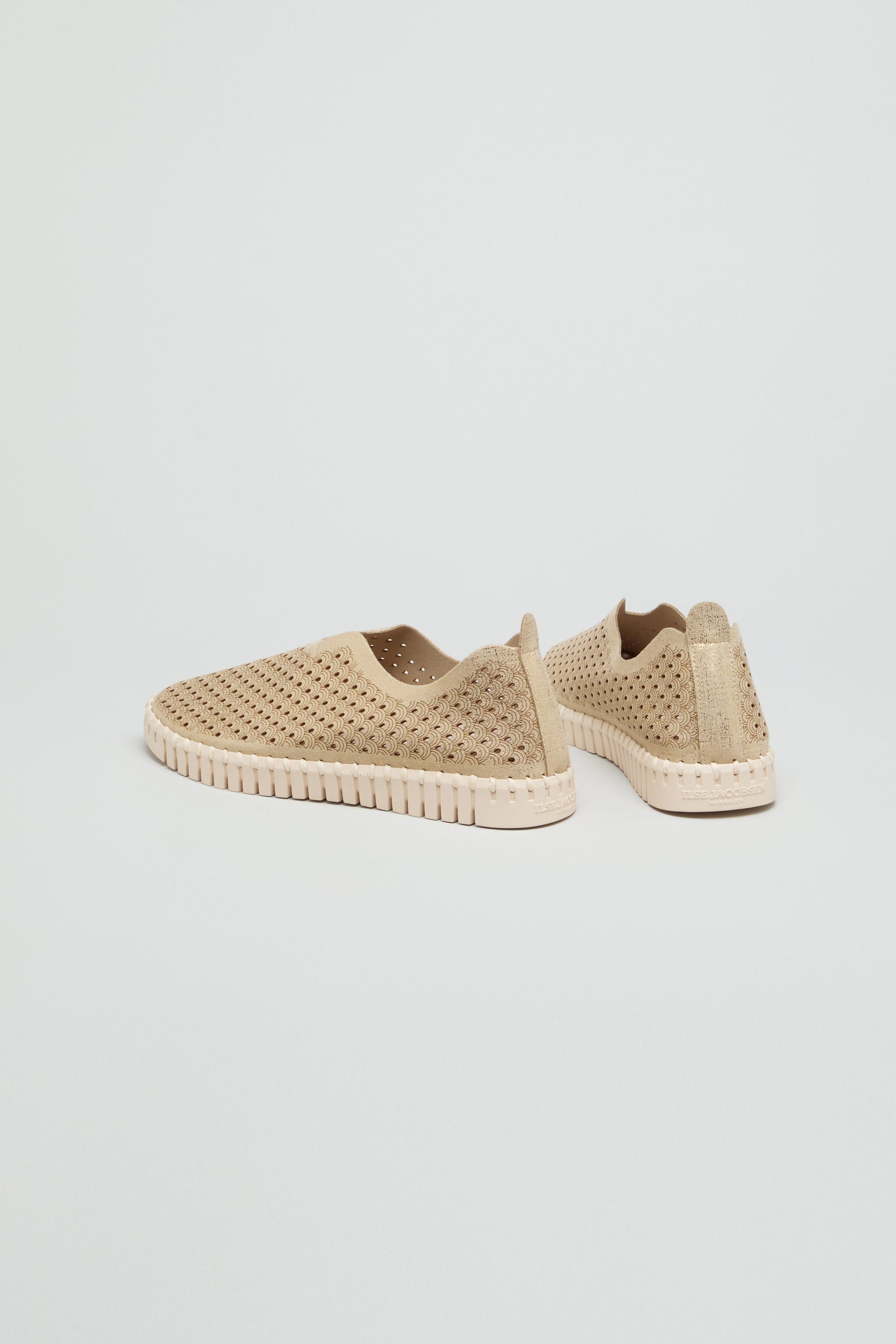 A pair of beige Tulip Glitter Slip on Shoes by Ilse Jacobsen, featuring perforations and textured soles, displayed on a plain white background.