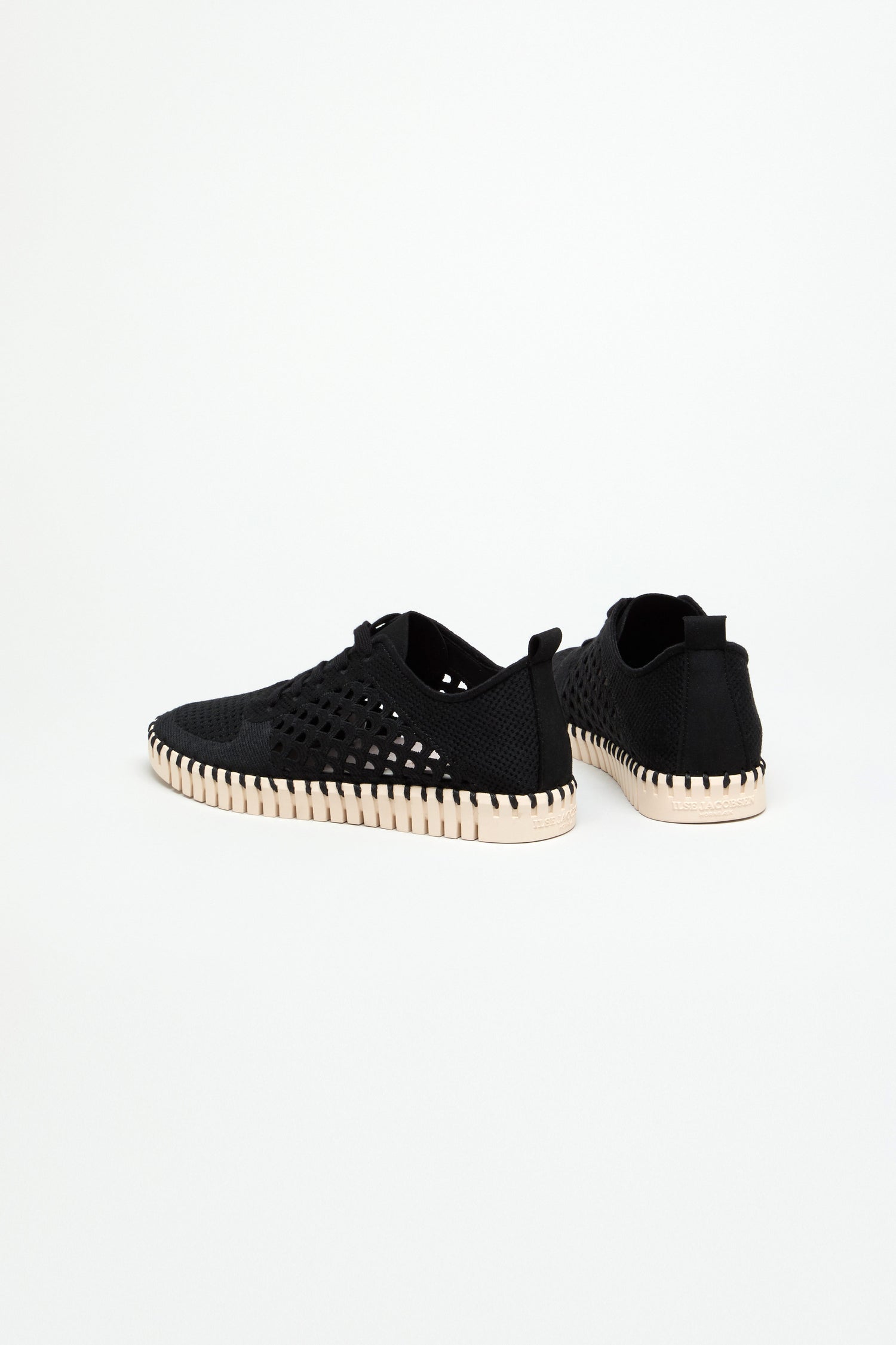 The Tulip Embroidered Lace Up Trainers, featuring perforated sides and white ribbed soles, are displayed on a plain white background to showcase these lightweight, breathable sneakers.