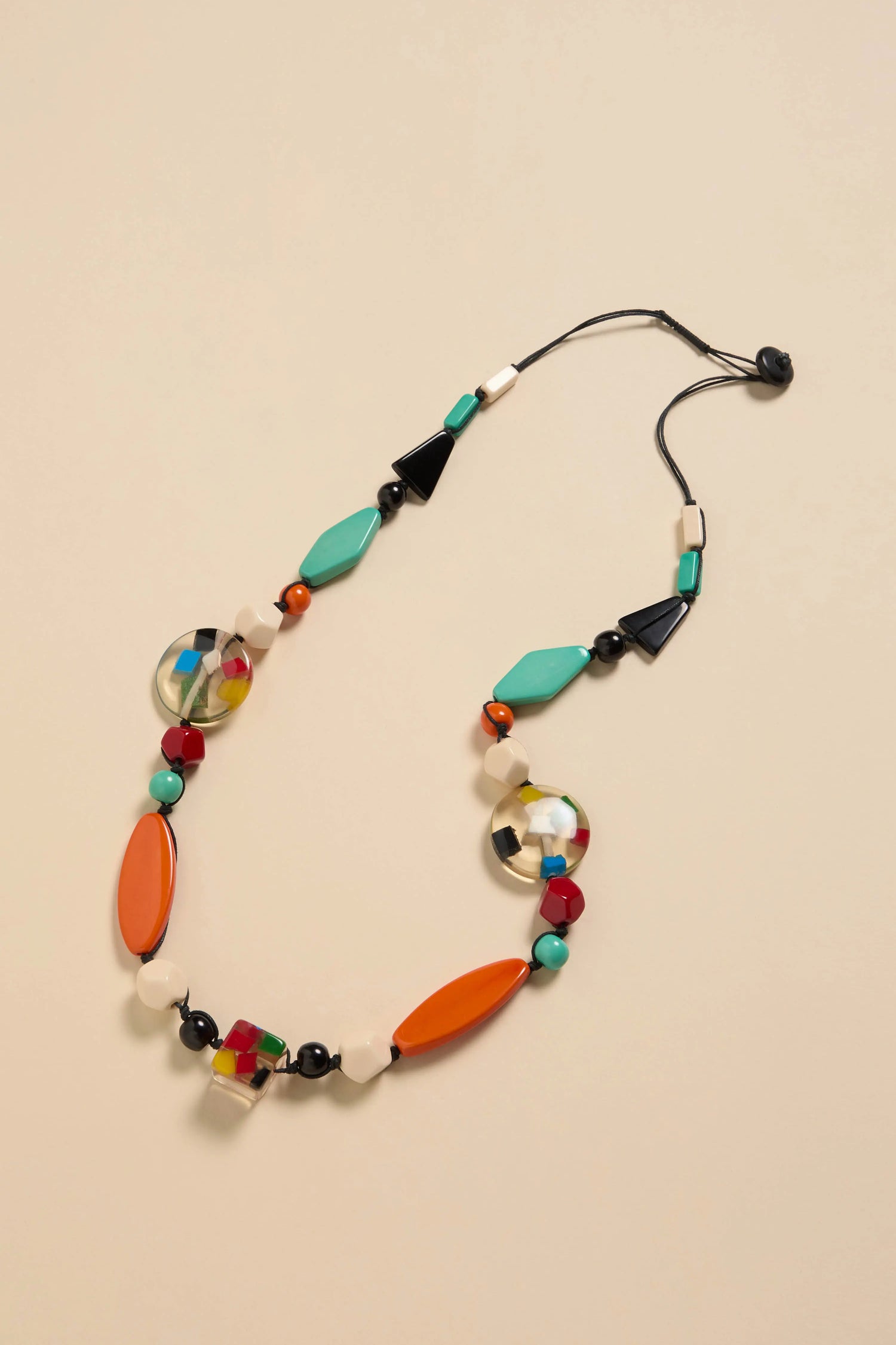 Colour Pop Resin Geometric Necklace featuring assorted geometric resin beads in orange, teal, black, and multicolored patterns on a black cord.