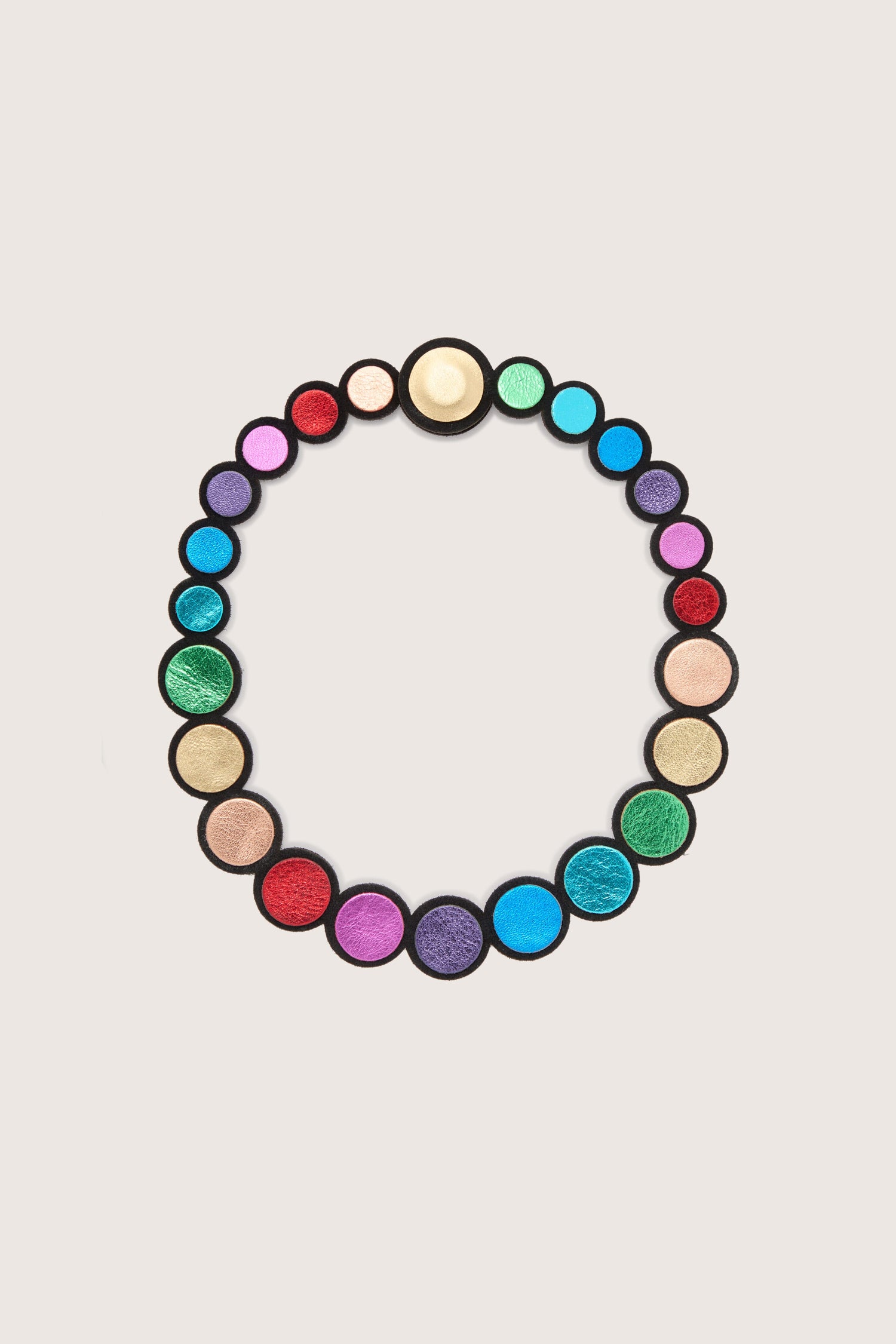 A vibrant and handmade Metallic Rainbow Leather Disc Necklace with a circle in the middle.