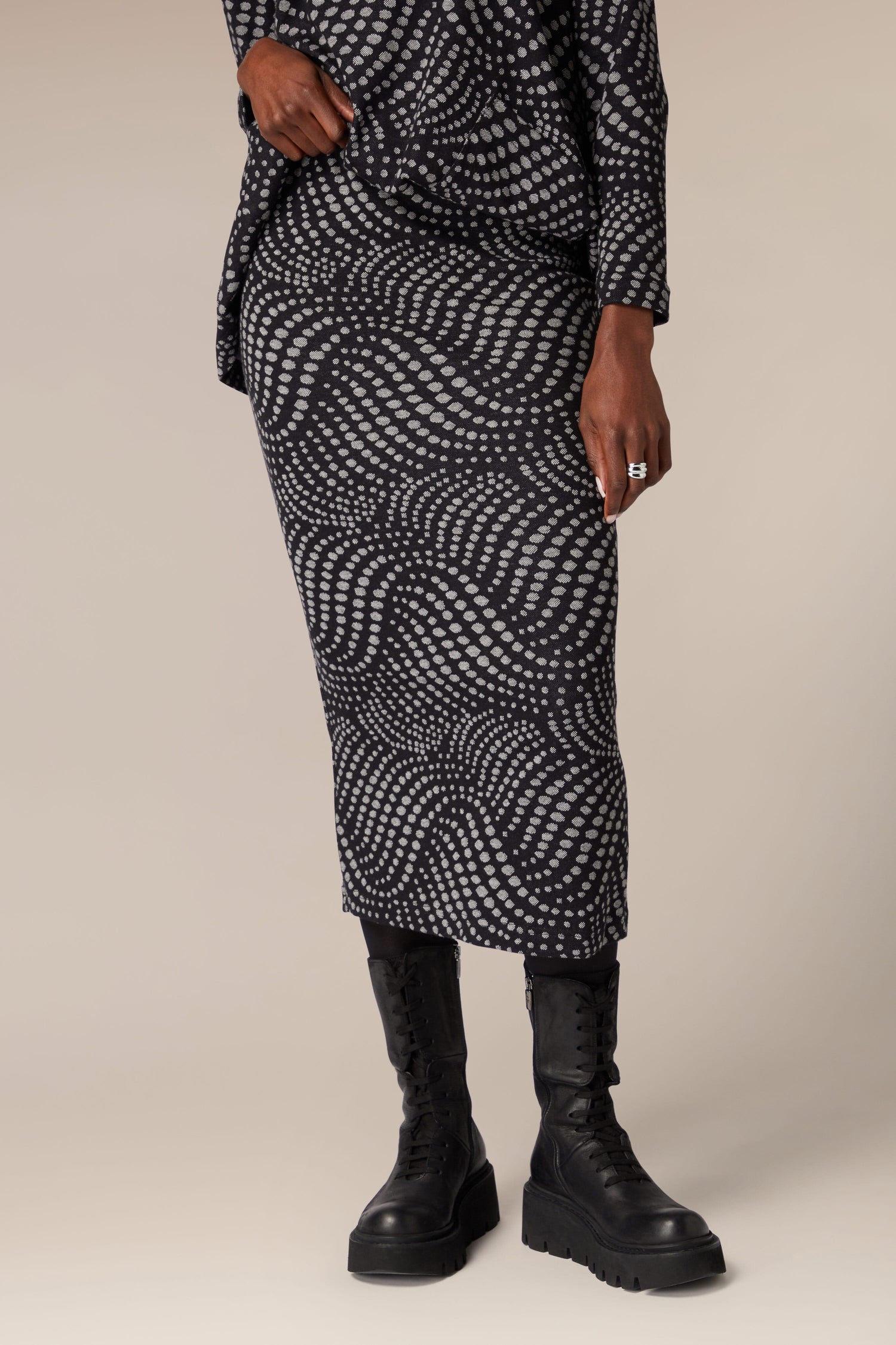 A woman donning a unique Spiral Spot Jersey Tube Skirt made of jersey material.