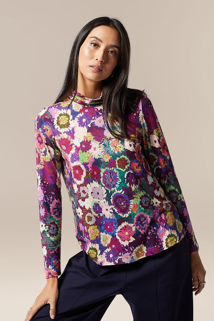 The model is wearing a Midnight Garden Jersey Polo Neck.