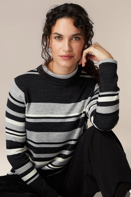 A woman showcasing her sophistication in a cozy Jersey Stripe Knit Polo Top.