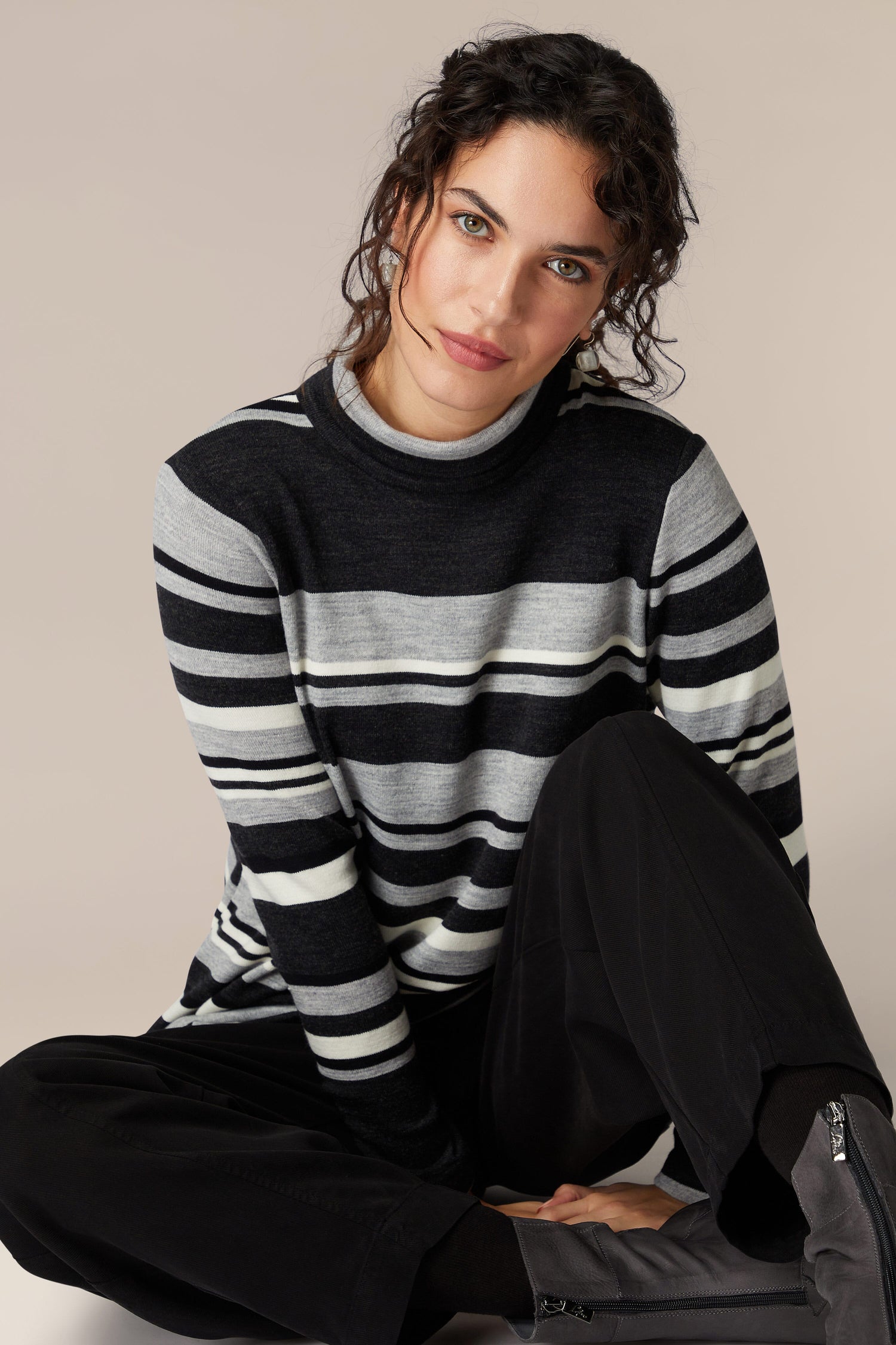 A woman exudes sophistication as she comfortably wears a Jersey Stripe Knit Polo Top.