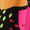 Close-up of the Mark Making Print Jersey Tunic's artistic fabric, showcasing bright orange, black, pink, and neon yellow-green dots—perfect for a vibrant look. Made in England.