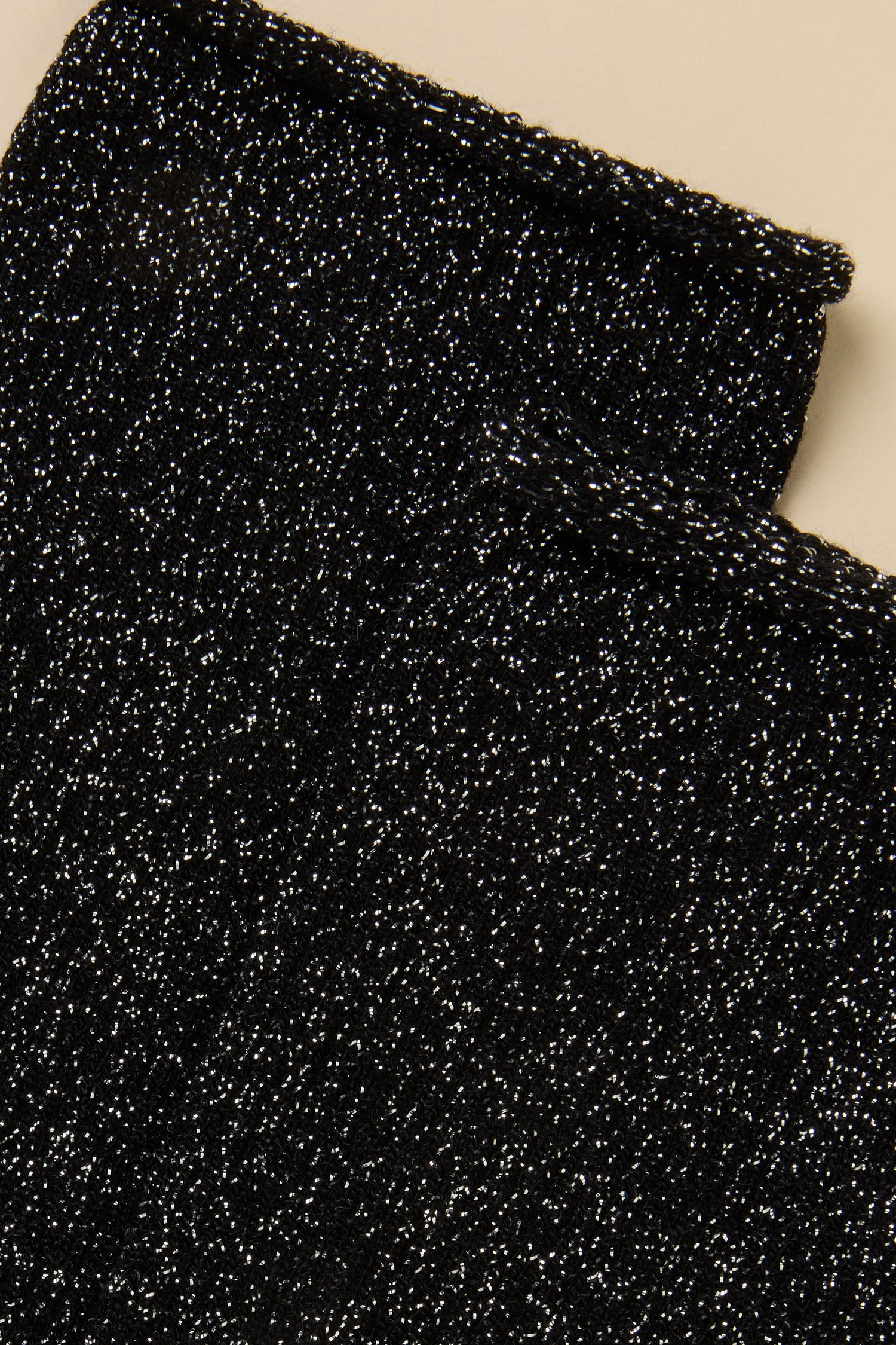 Close-up of Black Bamboo Sparkle Socks, featuring black lyocell-blend knit fabric with silver metallic fibre flecks.