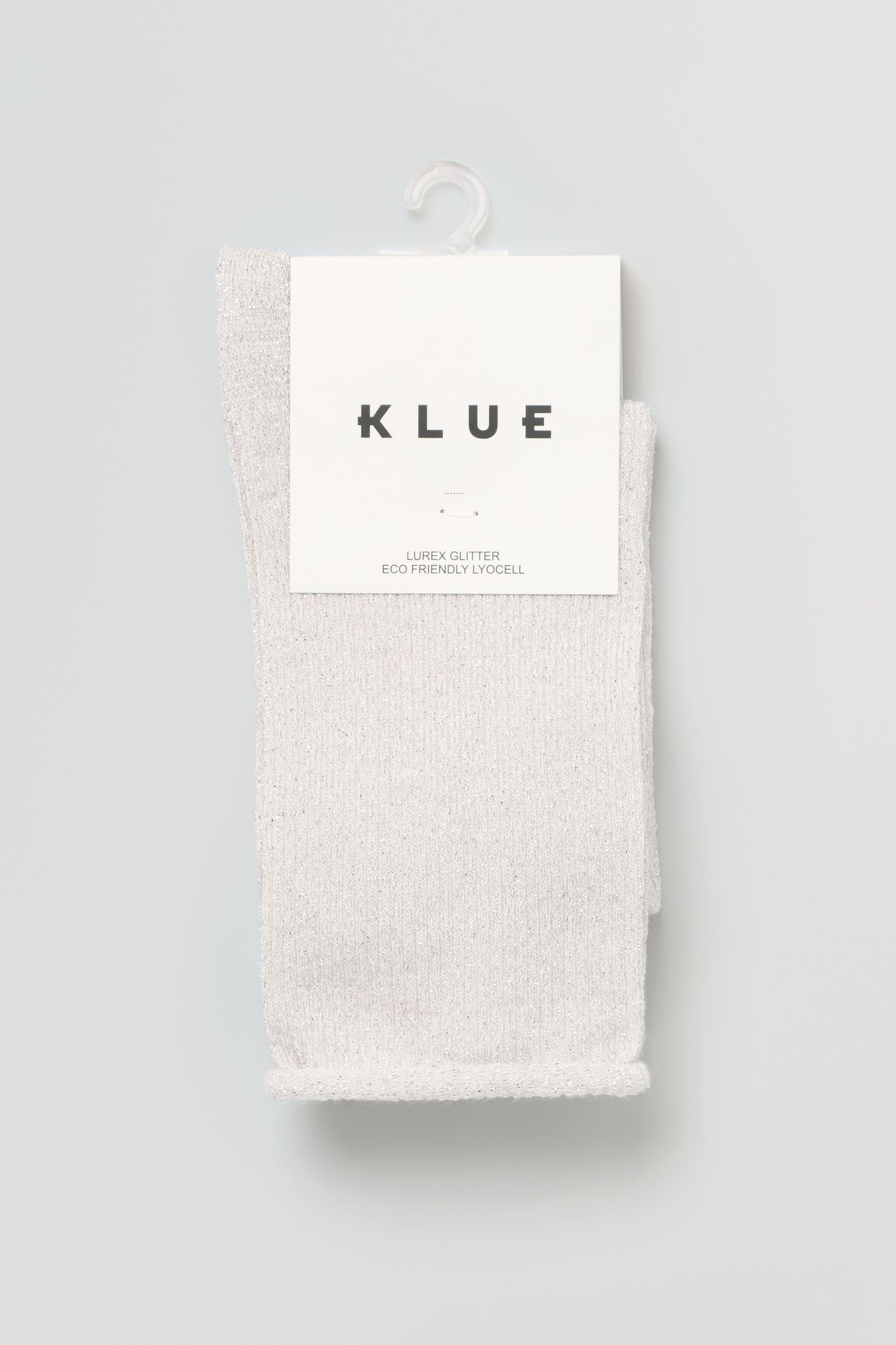 A pair of light gray Bamboo Sparkle Cloud Socks hang on a white plastic hook, labeled "KLUE" with "Eco Friendly Lyocell" printed on the packaging.