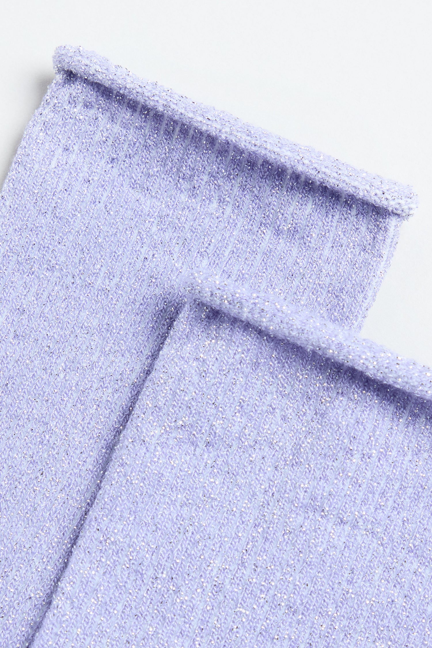 Close-up of two Bamboo Sparkle Lilac Socks, featuring light purple ribbed knit fabric with subtle metallic lurex threads for a hint of shimmer.