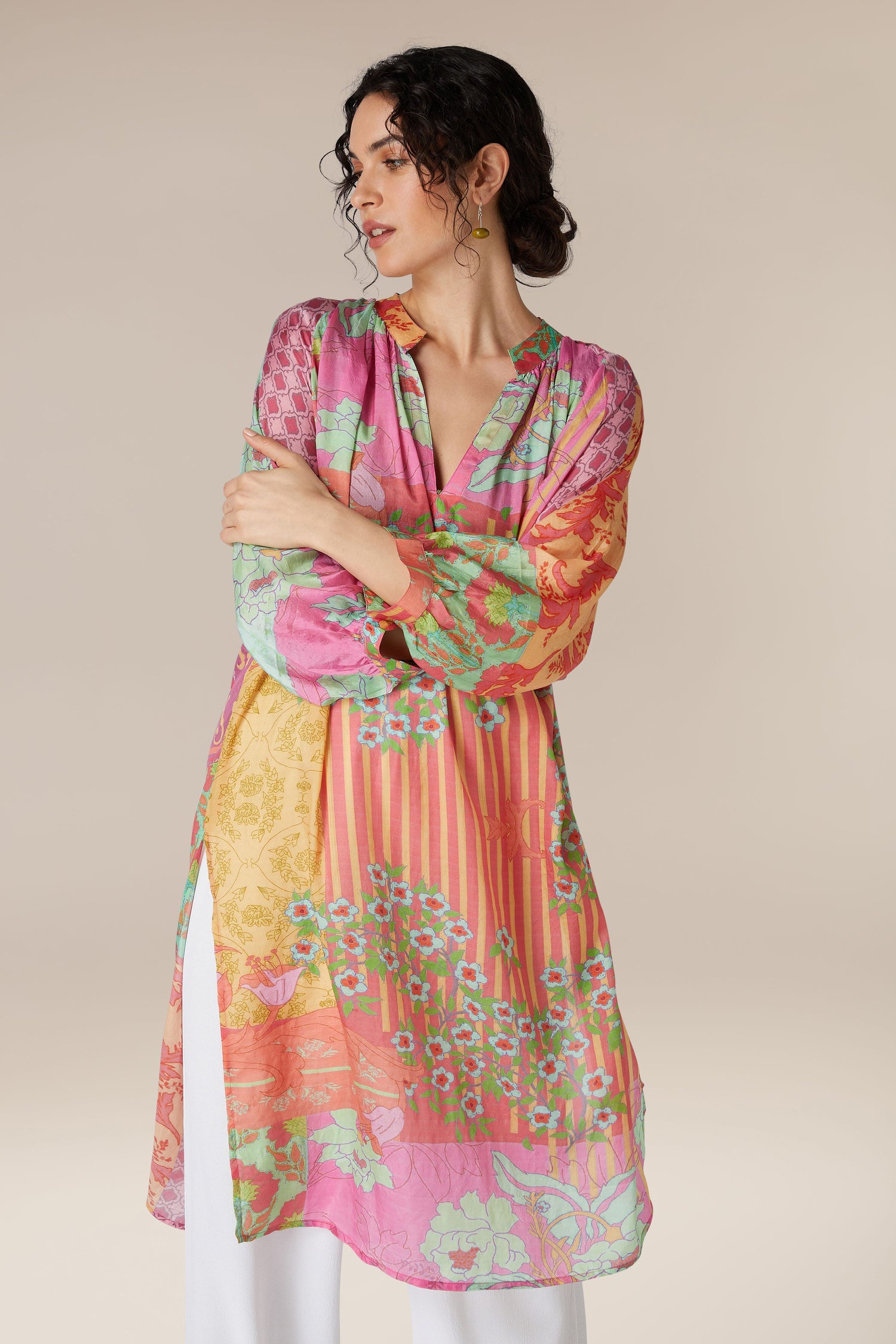 Woman wearing a colorful Geometric Floral Silk Beach Dress, posing with crossed arms.