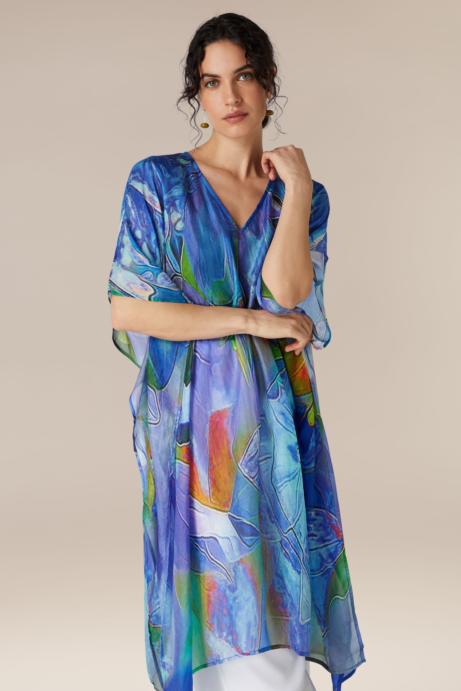 A woman in a Tiffany Lamp Silk V Neck Kaftan posing against a neutral background.