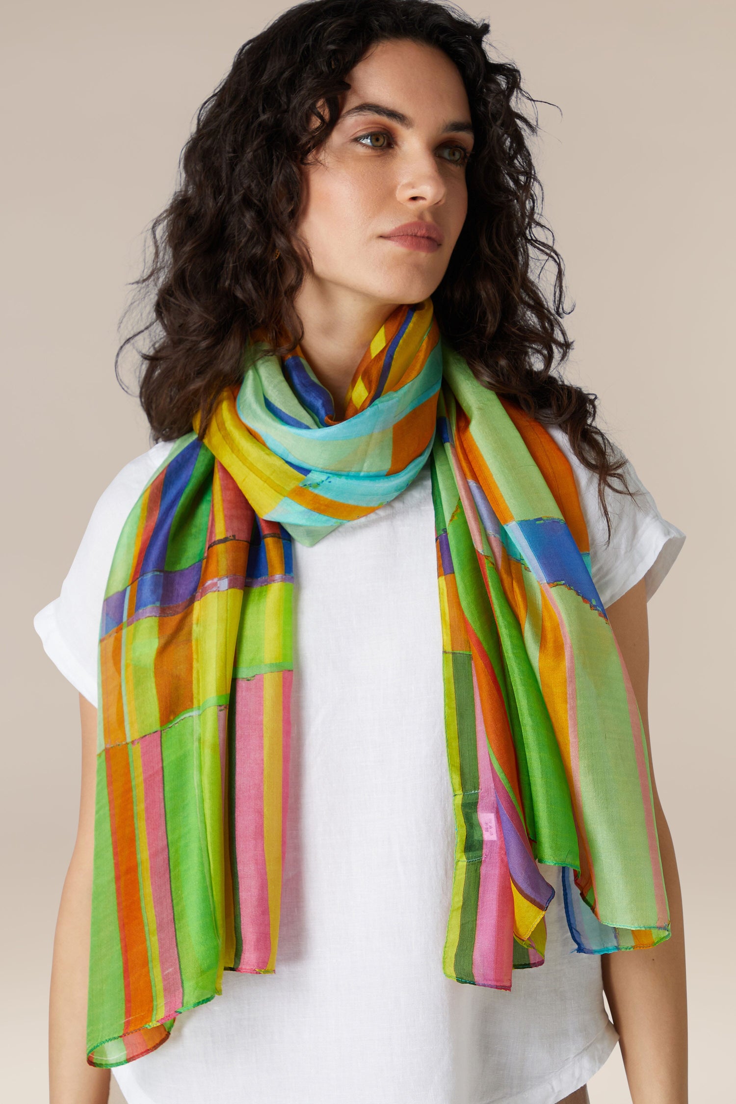 Woman wearing a white shirt and a Geometric Silk Scarf as her summer accessory.