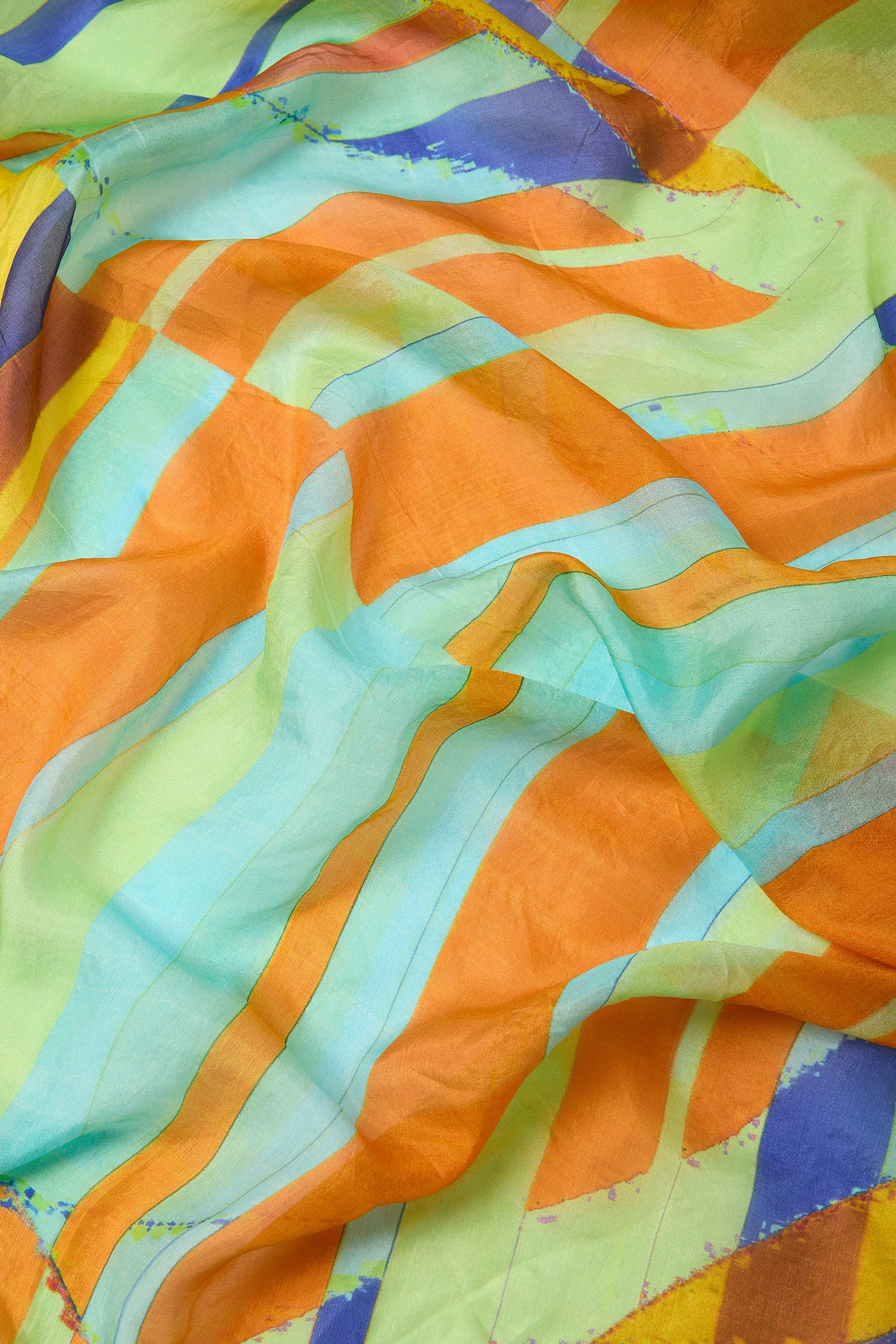 Geometric Silk Scarf with a vibrant geometric pattern draped loosely to showcase its design as a summer accessory.