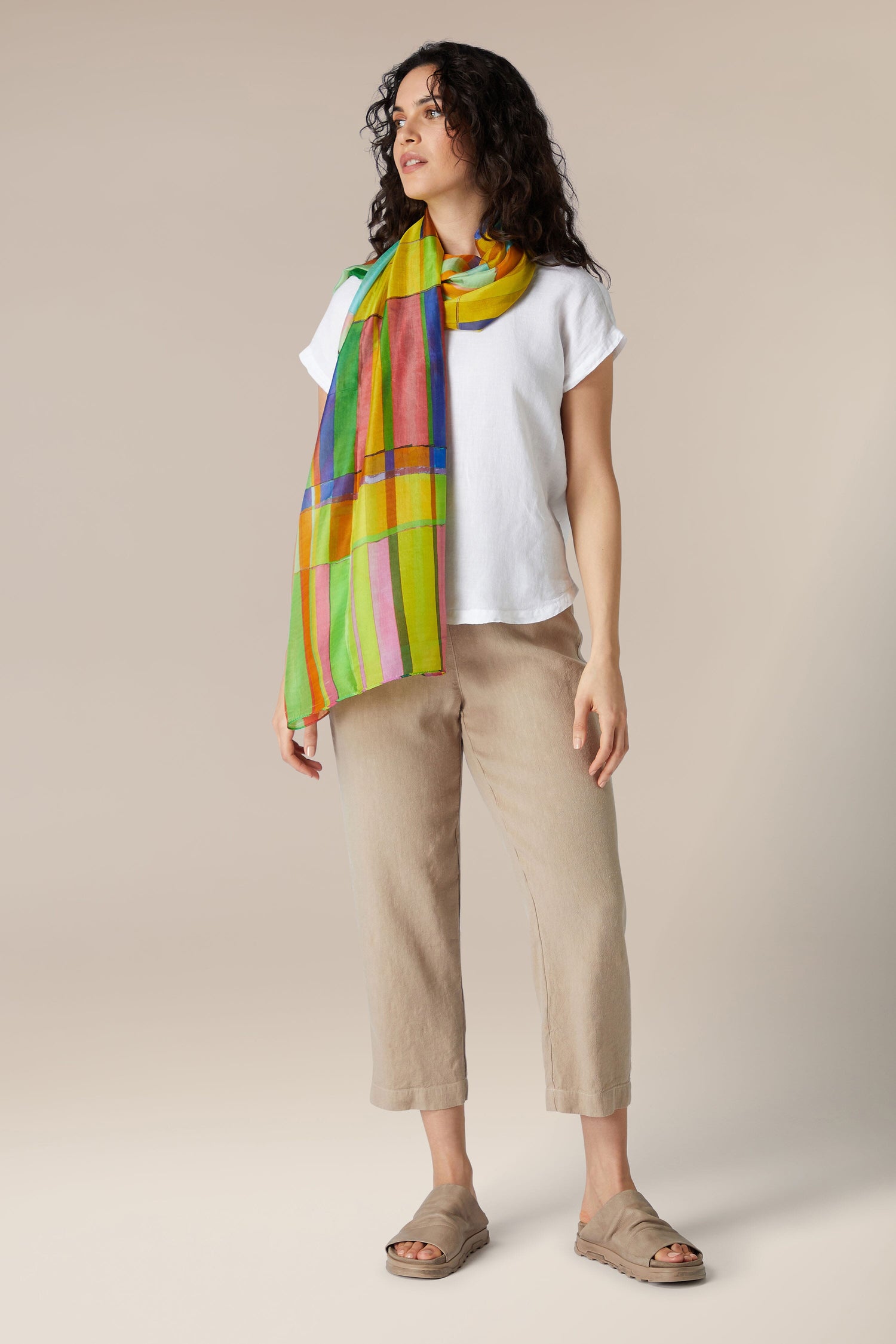 Woman in casual attire with a vibrant Geometric Silk Scarf.