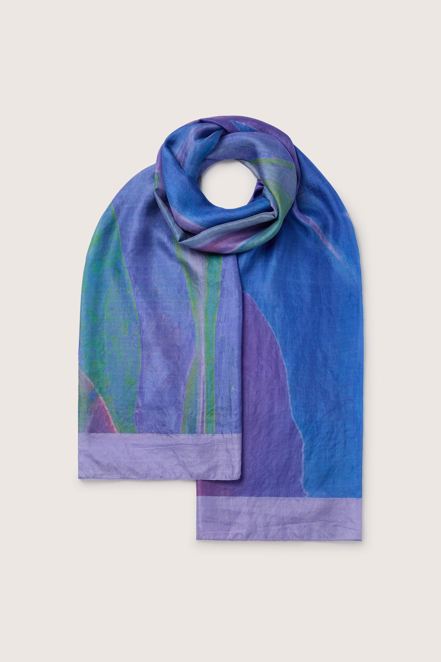 A Lilac Sky Silk Scarf with green accents displayed on a white background.