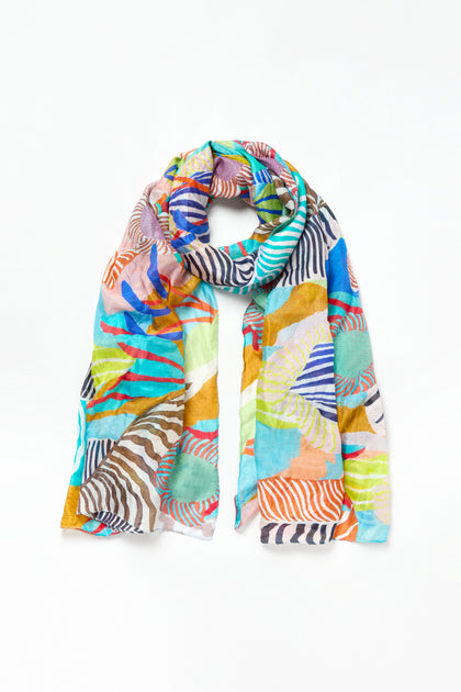 The Tropical Orchid Fantasy Silk Scarf is a lightweight silk accessory with a vibrant abstract pattern in blue, orange, green, yellow, and brown on white—ideal for adding a tropical flair to any outfit.