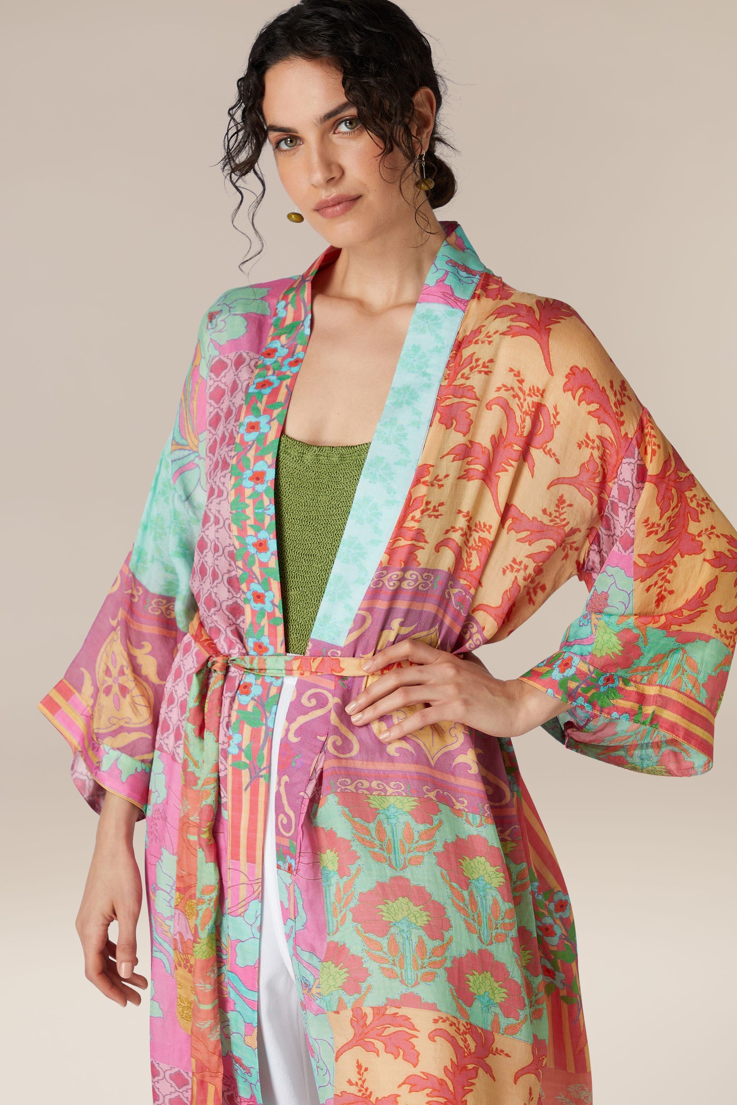 Woman posing in a Geometric Floral Silk Kimono with a green top.