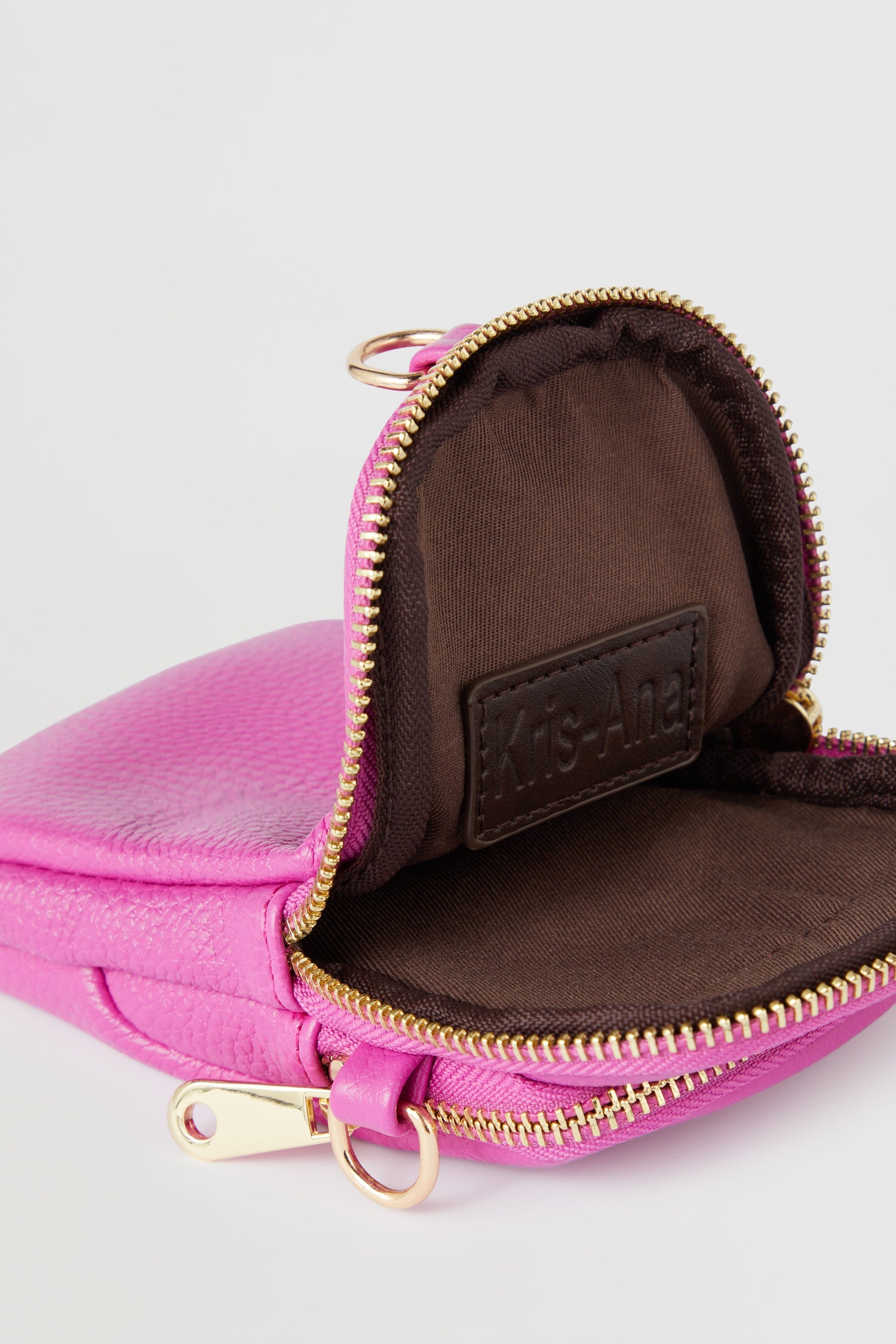 A pink Mini Crossbody Bag with a gold zipper, perfect for bags and style-led designs.