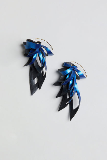 Metallic Blue Flipped Leaves Earrings featuring layered, leaf-like shapes in a gradient from blue to black, handcrafted from reclaimed bicycle inner tube and displayed on a plain white background.
