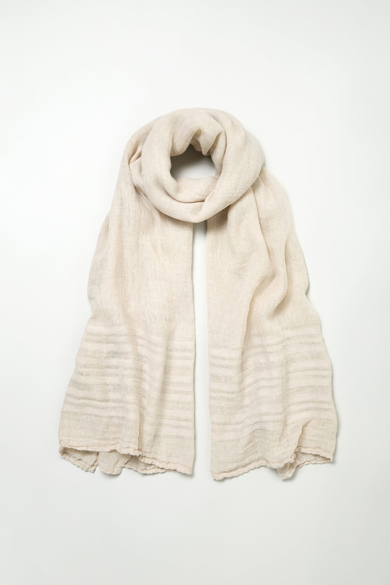 The Crinkle Linen Scarf, in beige with subtle horizontal textured stripes, is displayed flat on a plain white background.