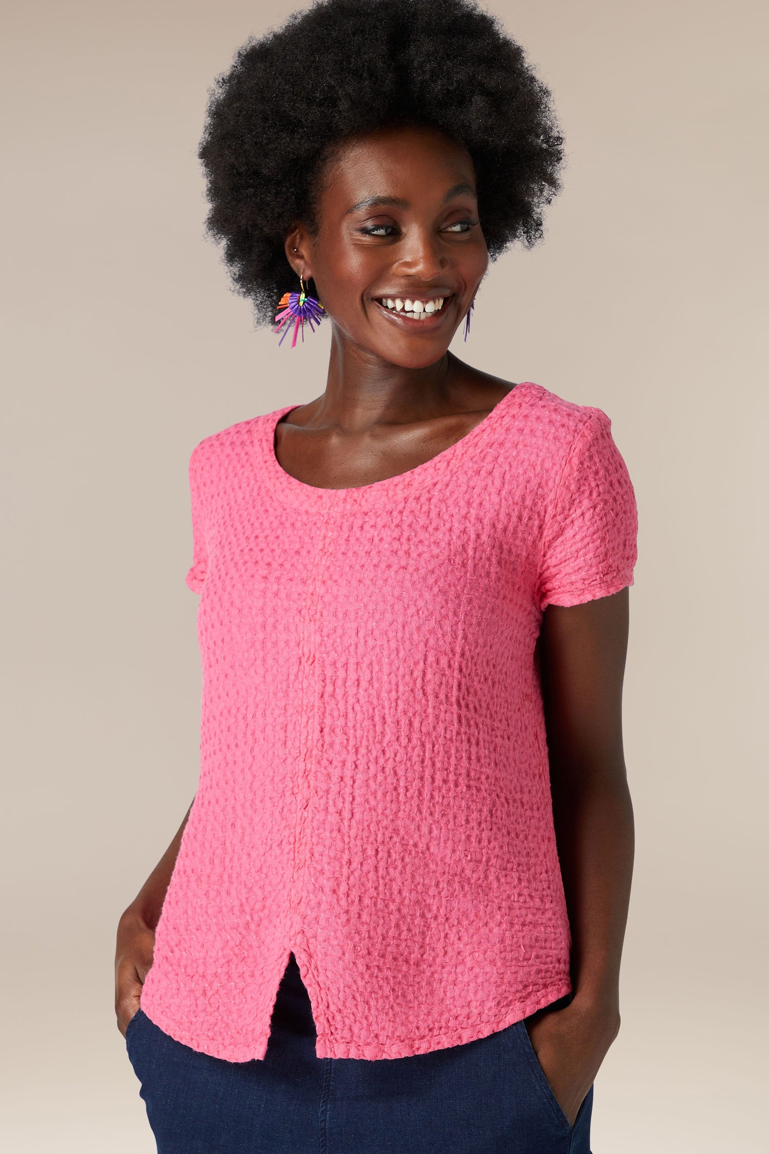 A black woman wearing a soft Waffle Linen Top in pink and jeans for an everyday look.