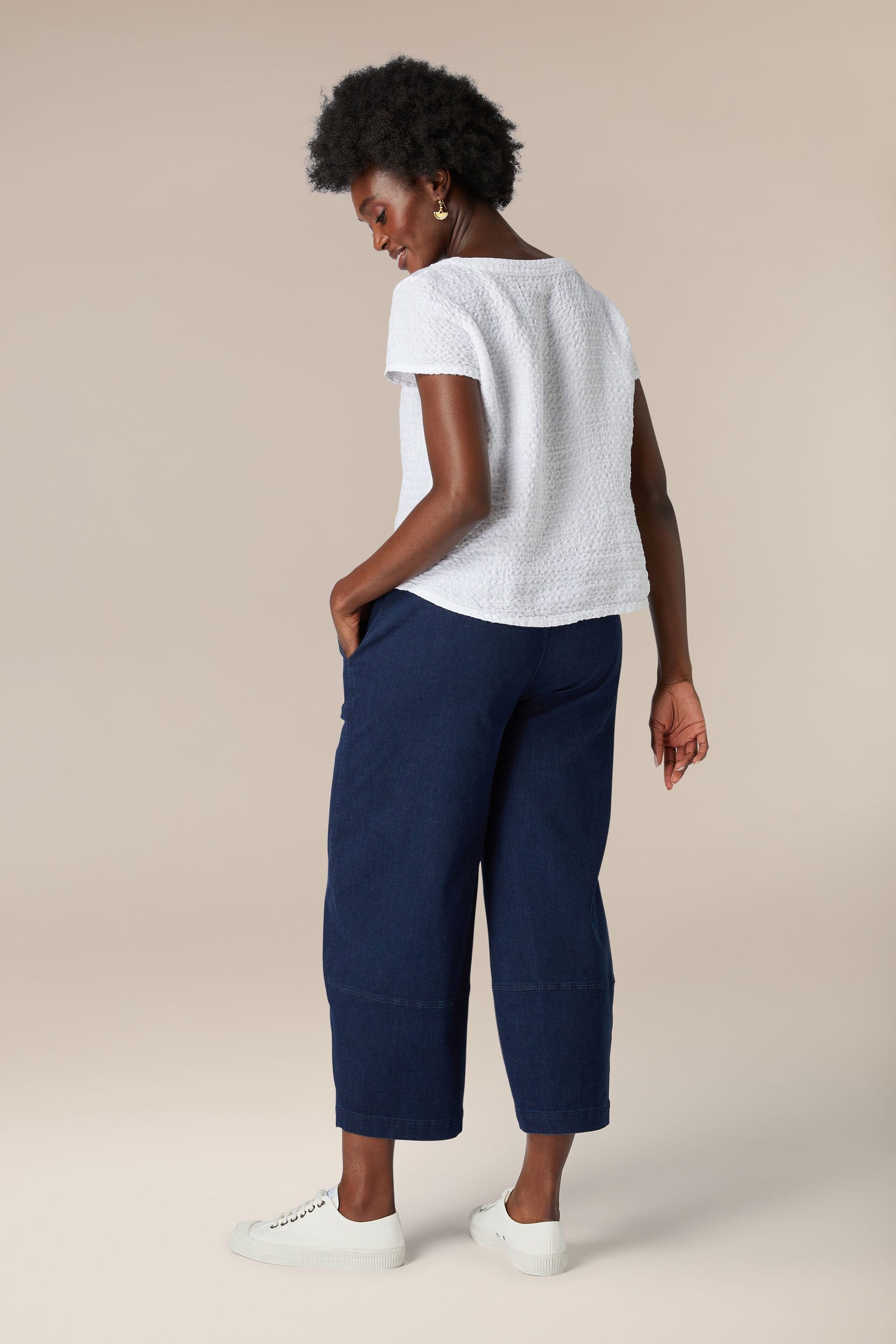 A woman in a soft Waffle Linen Top and blue pants.