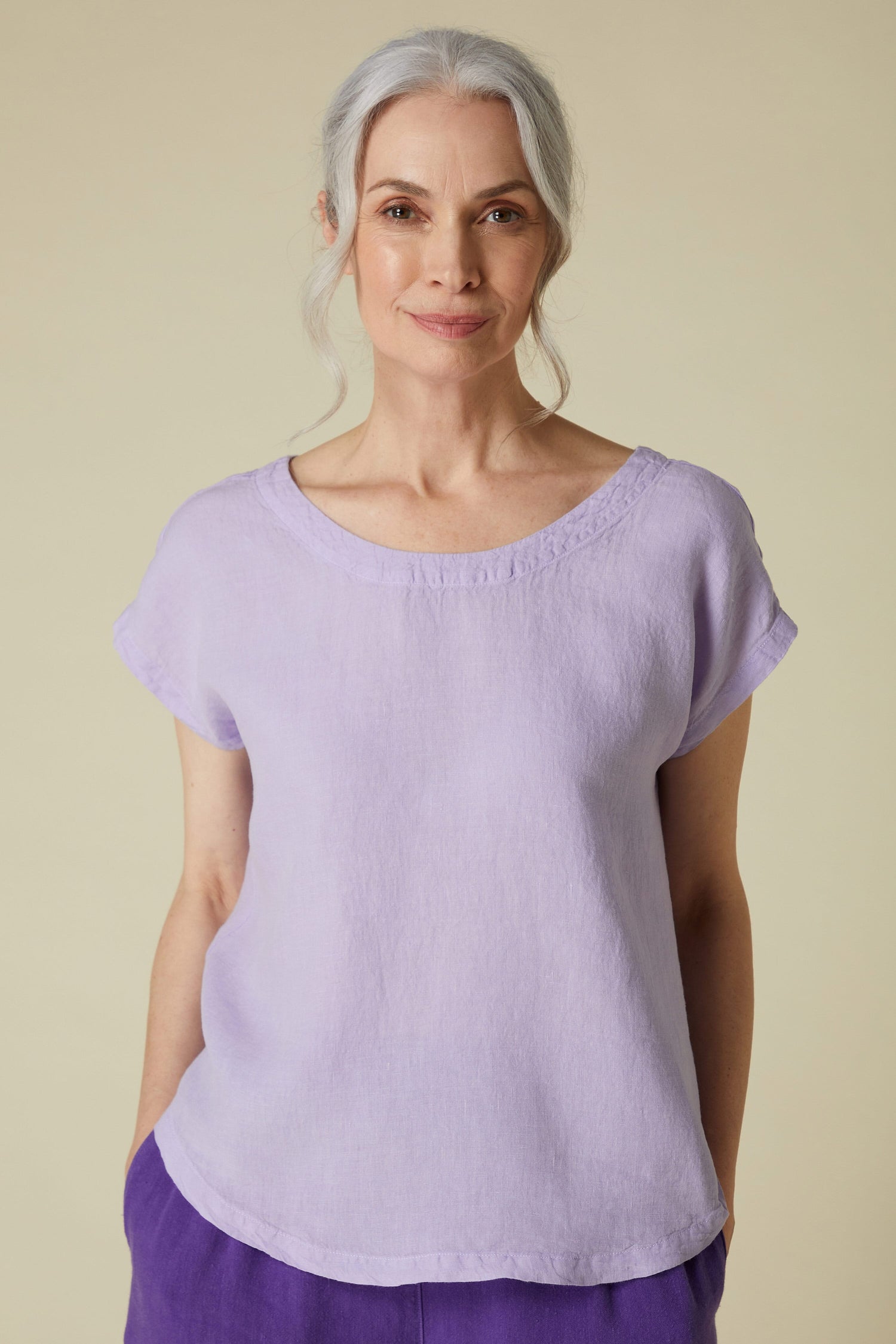 Mature woman with gray hair wearing a Organza Linen Reversible Top against a neutral background.