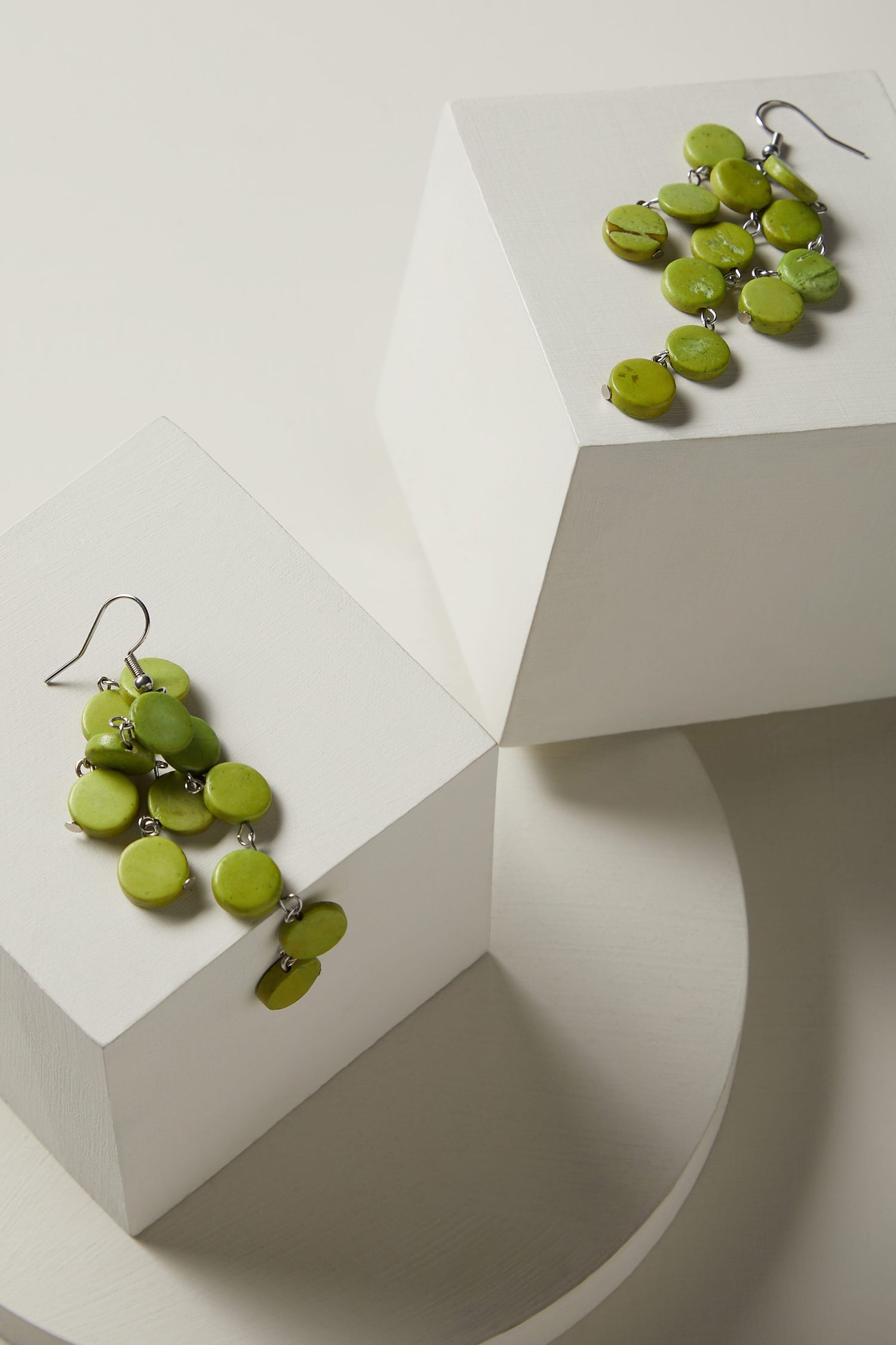 A pair of Cascade Earrings on top of a white box.