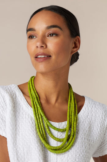 A woman wearing a Coconut Shell Disc Necklace.