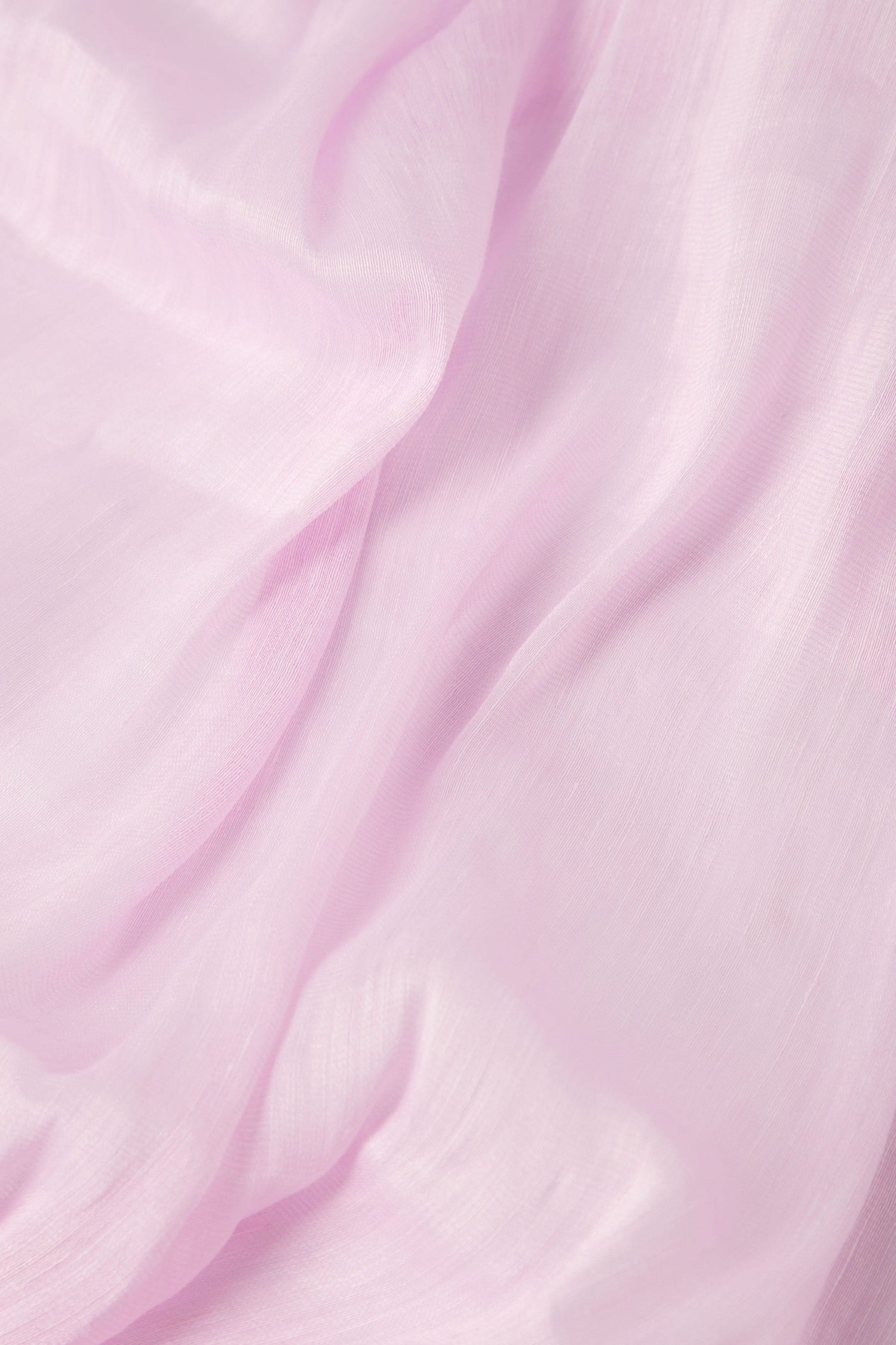 Close-up of a luxurious Soft Linen Scarf in soft, light pink fabric with gentle folds and a smooth texture.