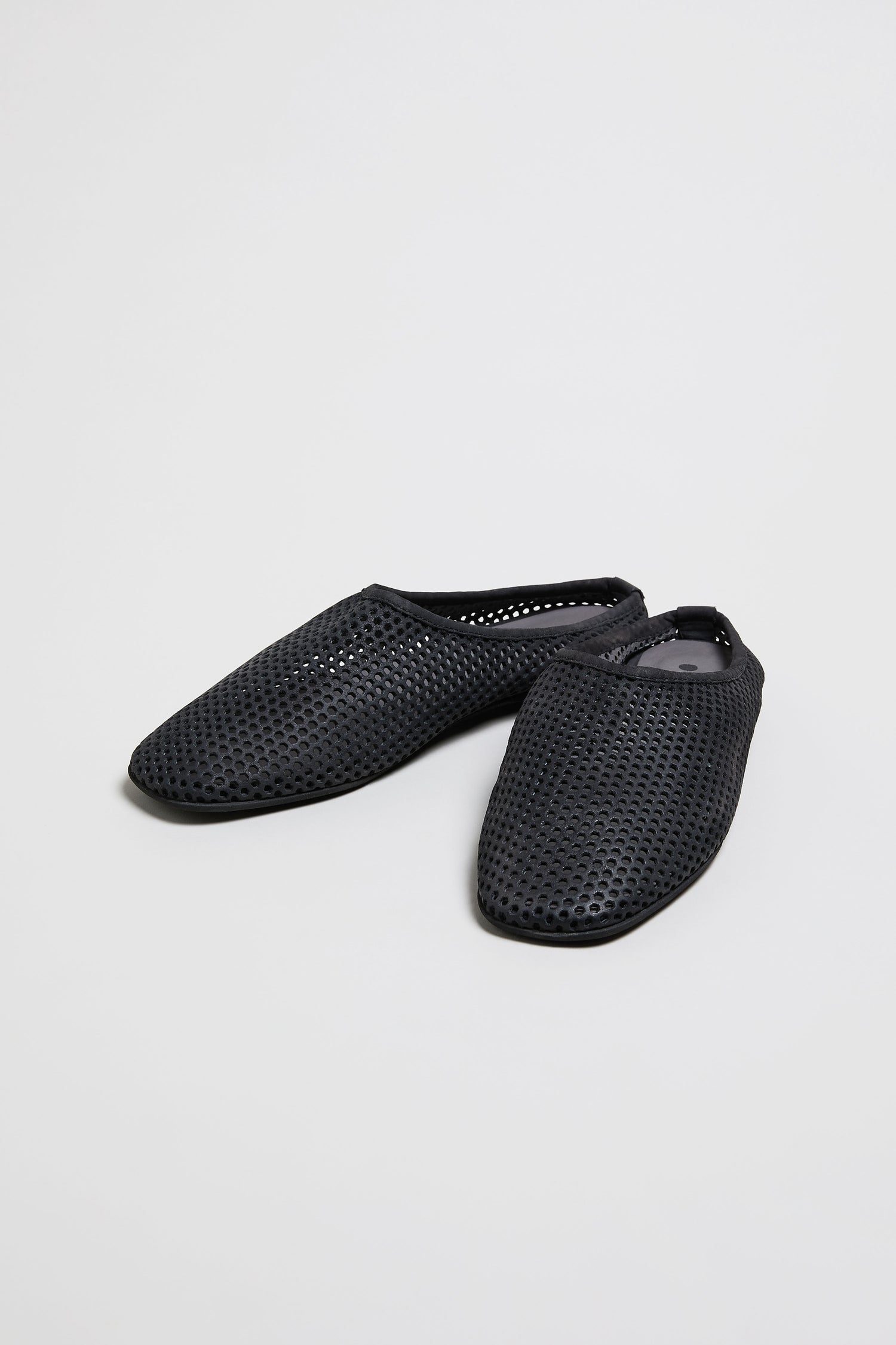 Mesh Leather Slip On Shoes: handmade in Europe, black with perforated mesh leather and pointed toes, shown on a plain light background.