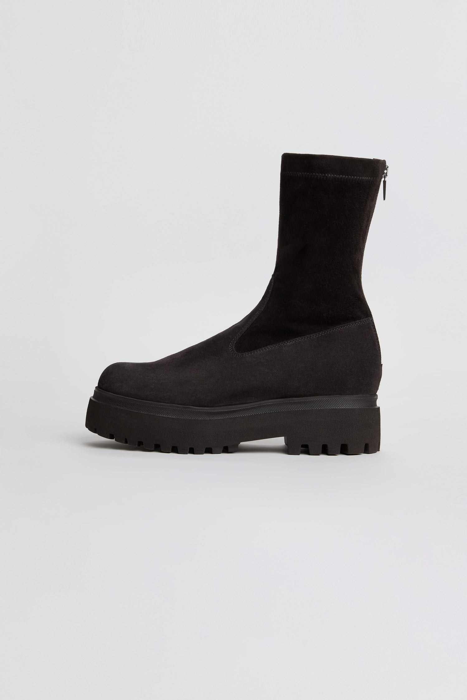 Short Stretch Suede Boots in black, featuring a chunky lug sole and a visible back zipper, photographed from the side against a plain white background.