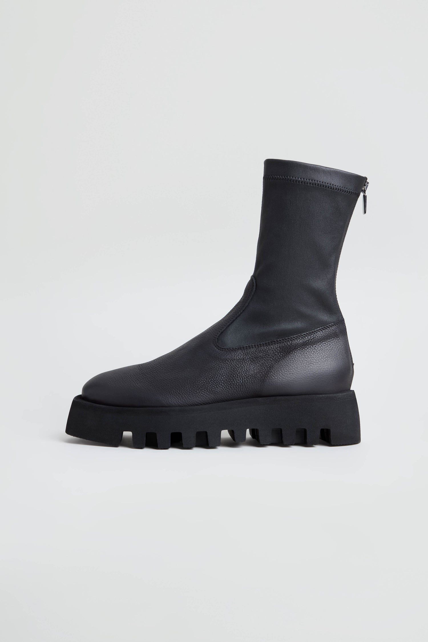Platform Napa Leather Stretch Boots in black leather with a thick, cleated platform sole and side zipper, displayed in a side profile view against a plain white background.