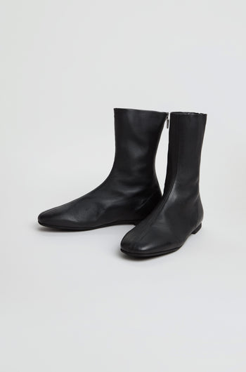 A pair of Slim Napa Leather Stretch Boots in black, featuring a mid-calf slim design with side zippers, displayed on a plain white background.