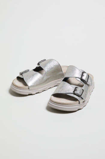 Double Buckle Leather Sliders in metallic silver feature two adjustable buckle straps and white rubber soles, style LOFI1E240, shown on a plain white background.