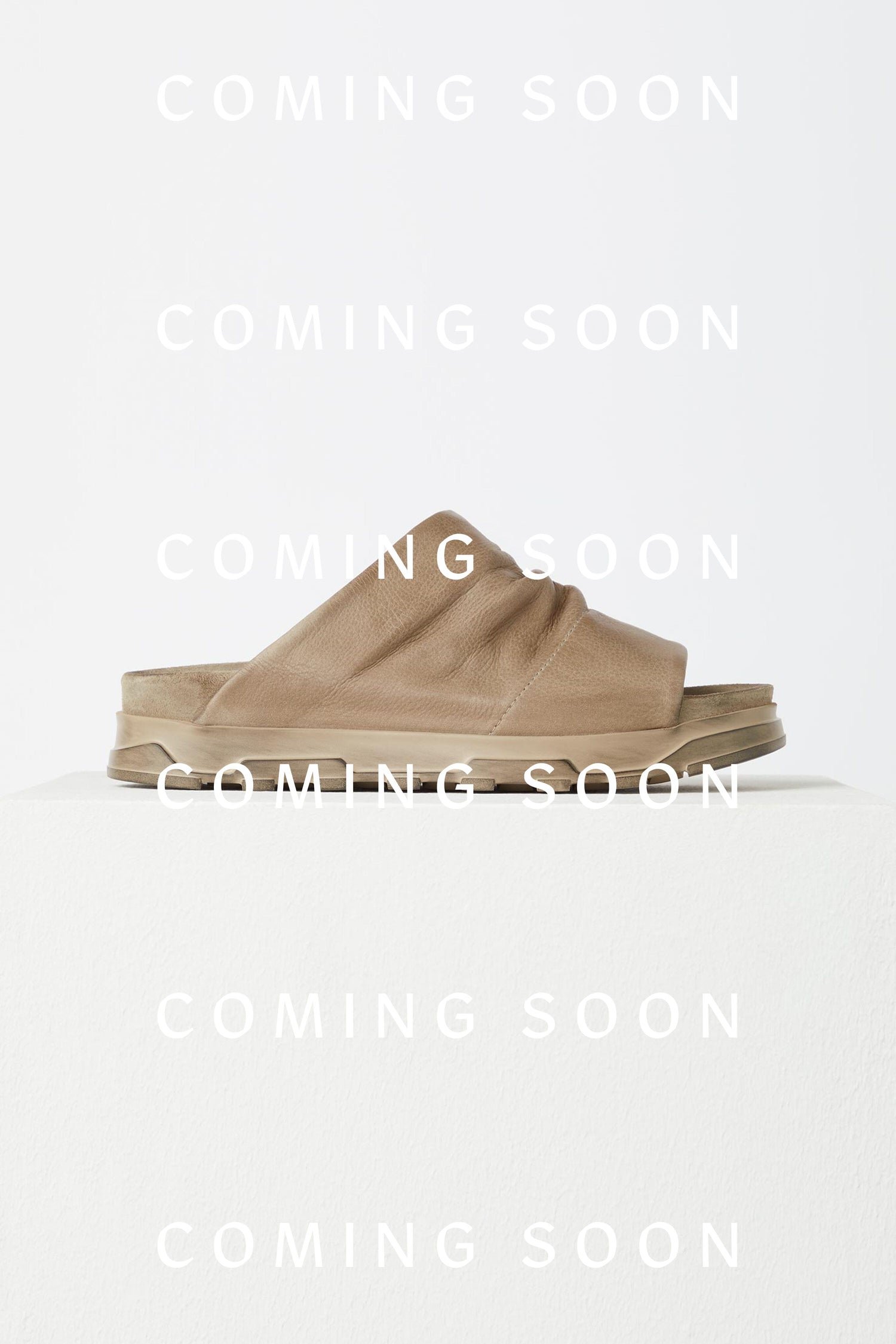 Crushed Leather Slider sandals featuring the words "coming soon" on them.