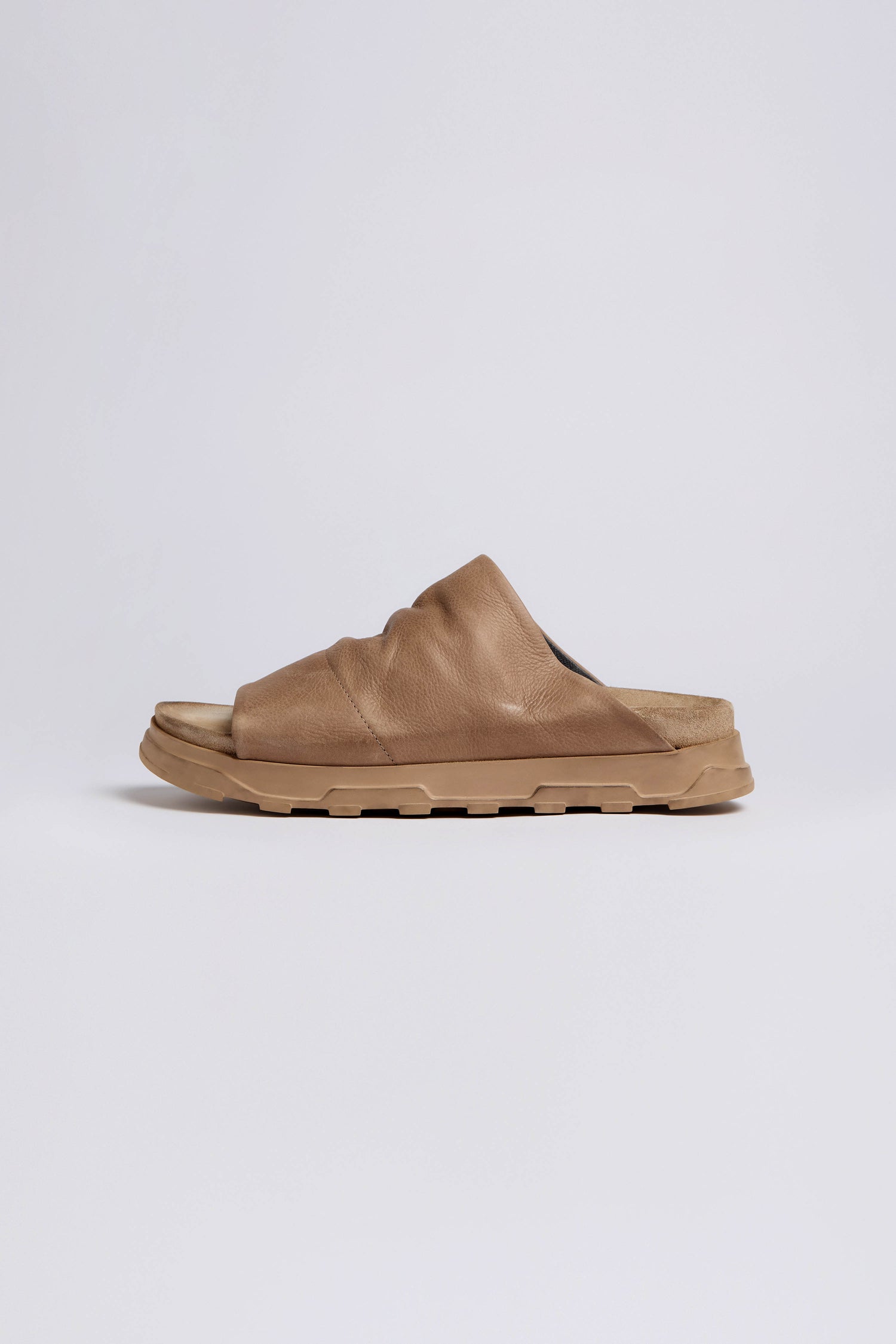 The Biscotti Crushed Leather Sliders, in brown with a thick sole, are shown from the side against a plain white background.