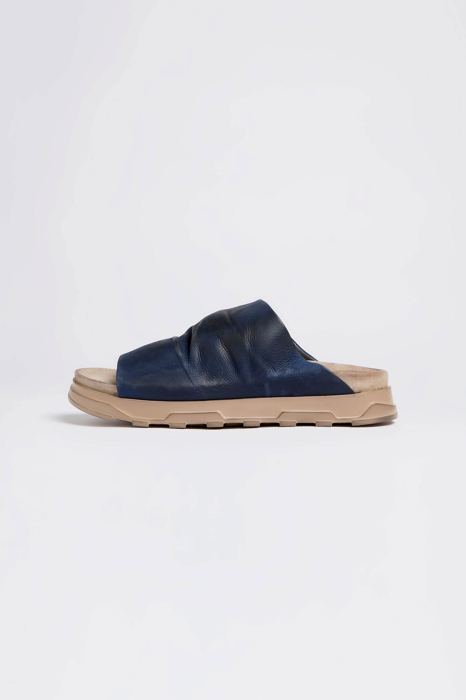 The Navy Crushed Leather Sliders feature a beige sole against a plain white background.