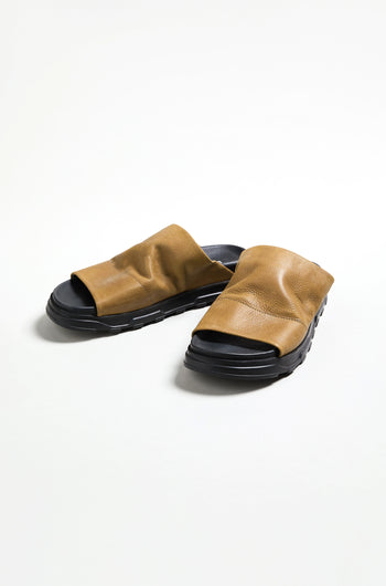 A pair of Crushed Leather Sliders with brown leather and black soles by Lofina, made in Italy, displayed on a plain white background.