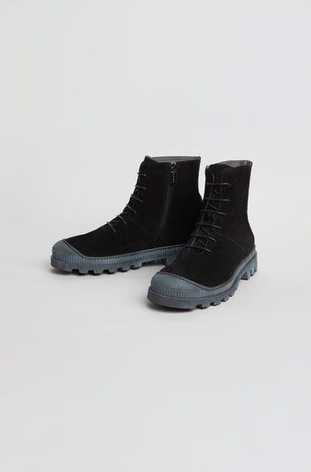 Pair of black Lace Up Suede Boots featuring suede construction, lace-up design, thick treaded rubber soles, side zippers, and round toes, set against a plain white background.