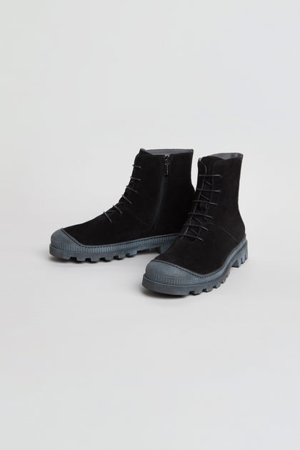 Pair of black Lace Up Suede Boots featuring suede construction, lace-up design, thick treaded rubber soles, side zippers, and round toes, set against a plain white background.