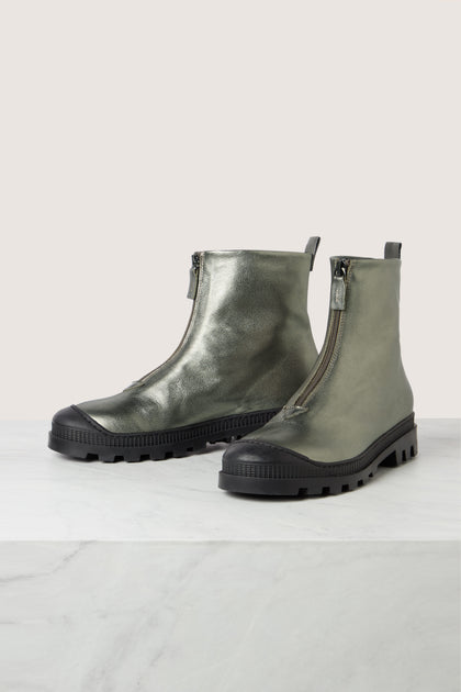 A pair of metallic green zip front leather boots by Lofina, featuring black rubber soles and round toes, displayed on a light-colored surface.