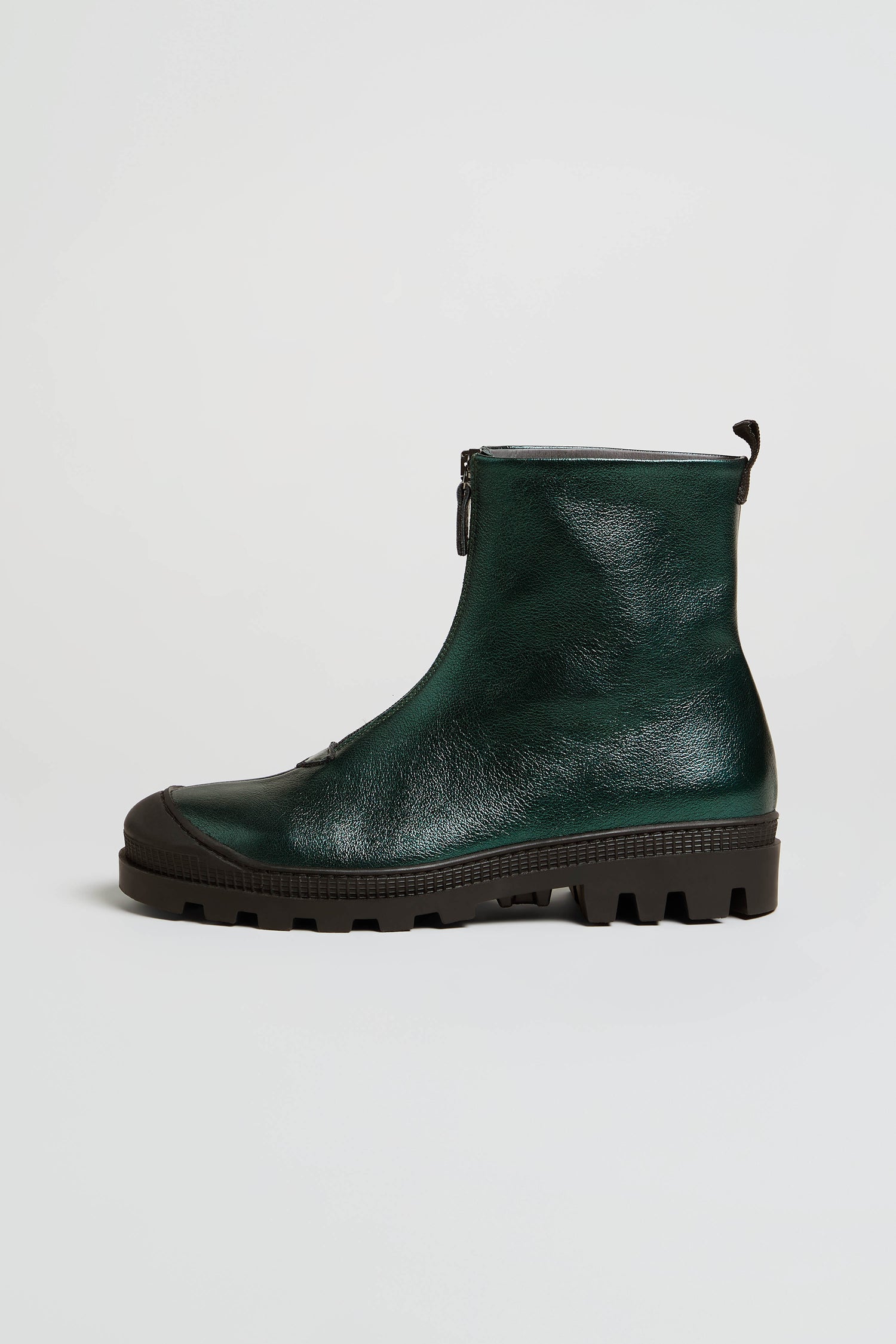 The Metallic Forest Zip Front Leather Boot, featuring dark green textured leather, a chunky tread sole, and a front zipper closure, is displayed on a plain white background.