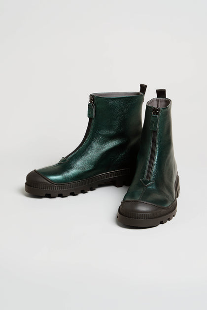 A pair of Metallic Forest Zip Front Leather Boots with chunky tread soles and thick black rubber outsoles displayed on a white background.