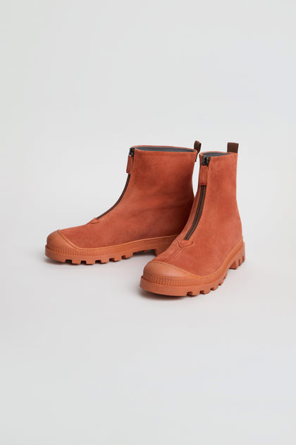 A pair of Zip Front Suede Boots in rust, handmade in Italy with front zippers and chunky rubber soles, displayed on a plain white background.