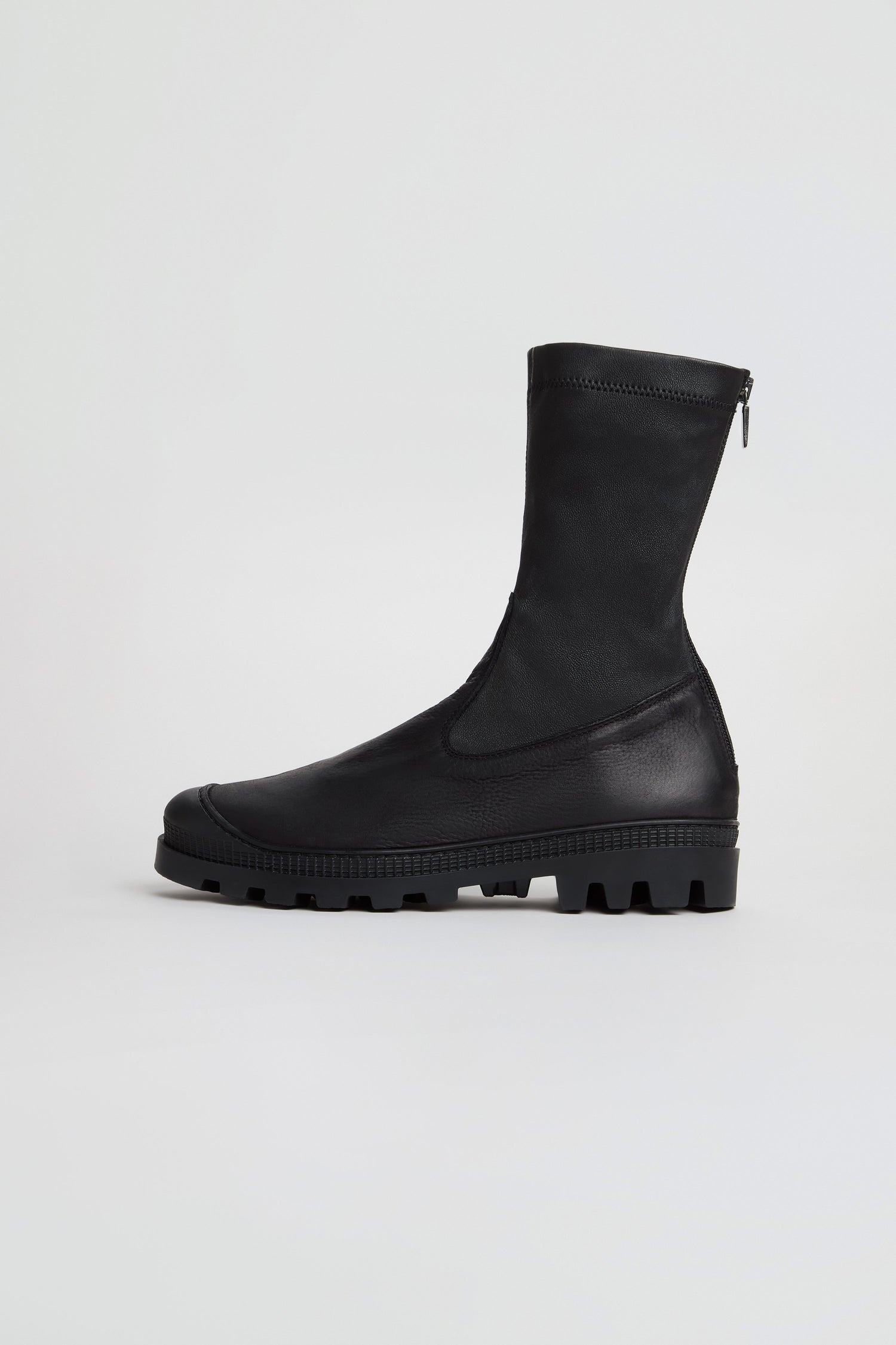 Stitch Detail Napa Leather Stretch Boots in black, featuring a mid-calf silhouette, chunky tread sole, and side zipper; crafted from nappa leather and handmade in Italy, showcased against a plain white background.